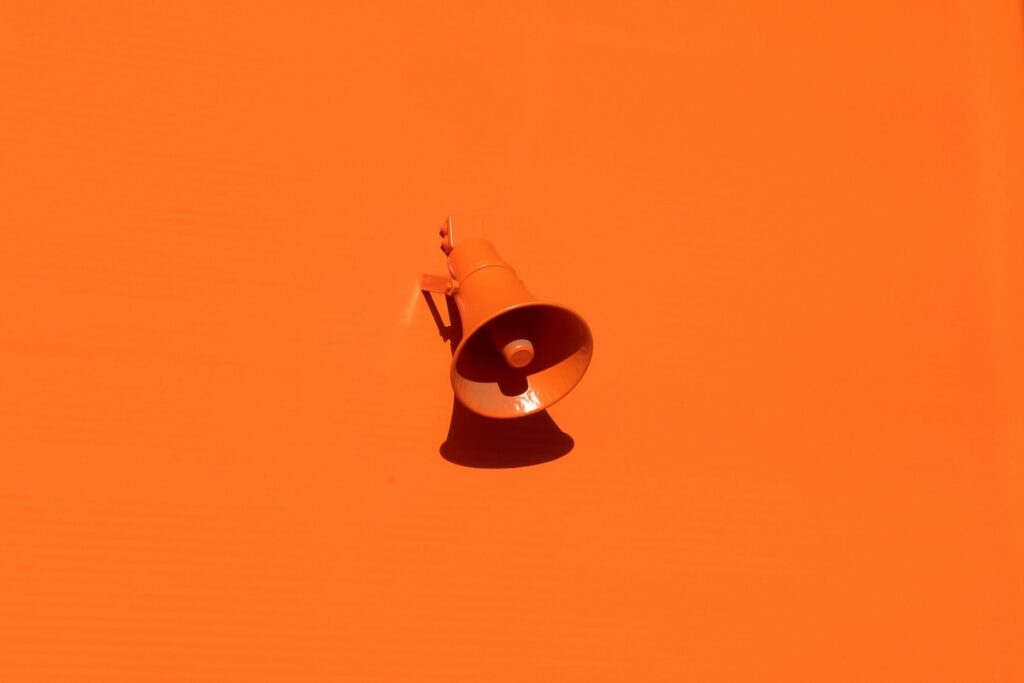 small business marketing system megaphone on orange background
