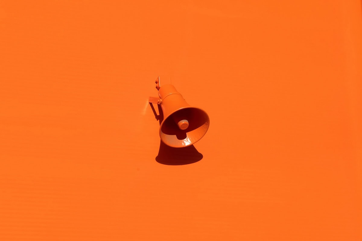 small business marketing system megaphone on orange background
